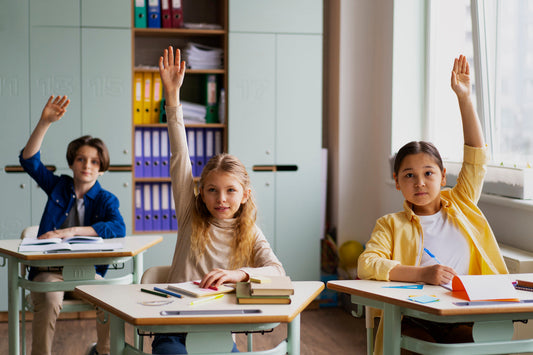 students raising hands active at school