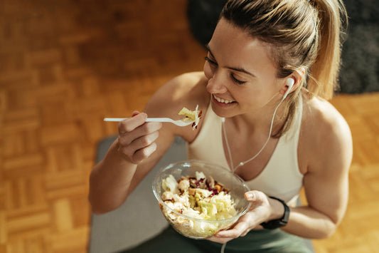woman eating a bowl of breakfast before working out
